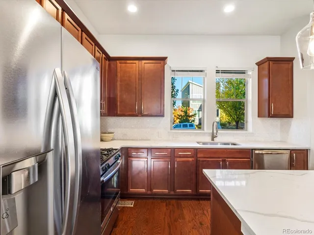 a bedroom with a bed a flat screen tv and a couch