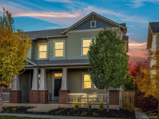 a view of an empty room with wooden floor and window