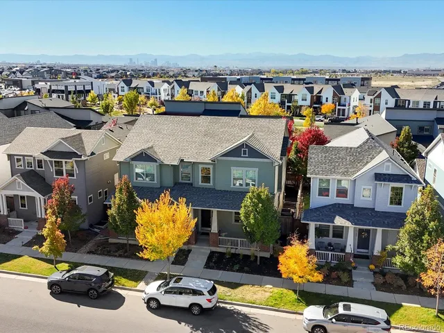 a kitchen with stainless steel appliances granite countertop a kitchen island a stove a refrigerator a sink a dining table and chairs with wooden floor