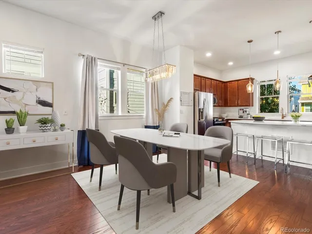 a kitchen with stainless steel appliances granite countertop a refrigerator a sink a stove and island