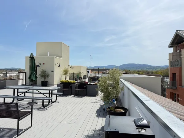 a view of a living room and a wooden deck