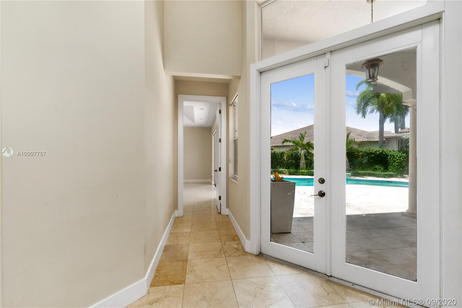 2467 Eagle Run Drive Weston, FL 33327 - Photo 12 of 33 a view of a hallway with wooden floor and a living room