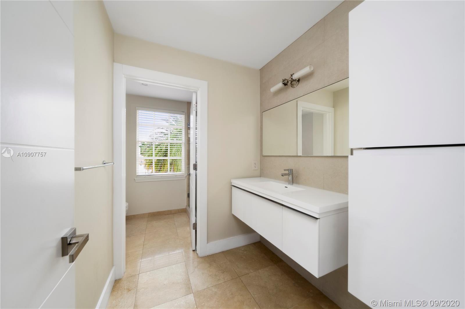 2467 Eagle Run Drive Weston, FL 33327 - Photo 21 of 33 a bathroom with a sink and a mirror