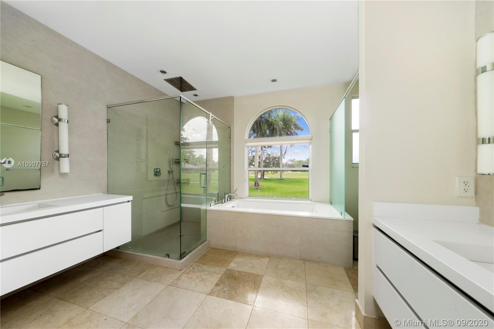 2467 Eagle Run Drive Weston, FL 33327 - Photo 25 of 33 a bathroom with a bathtub sink and mirror