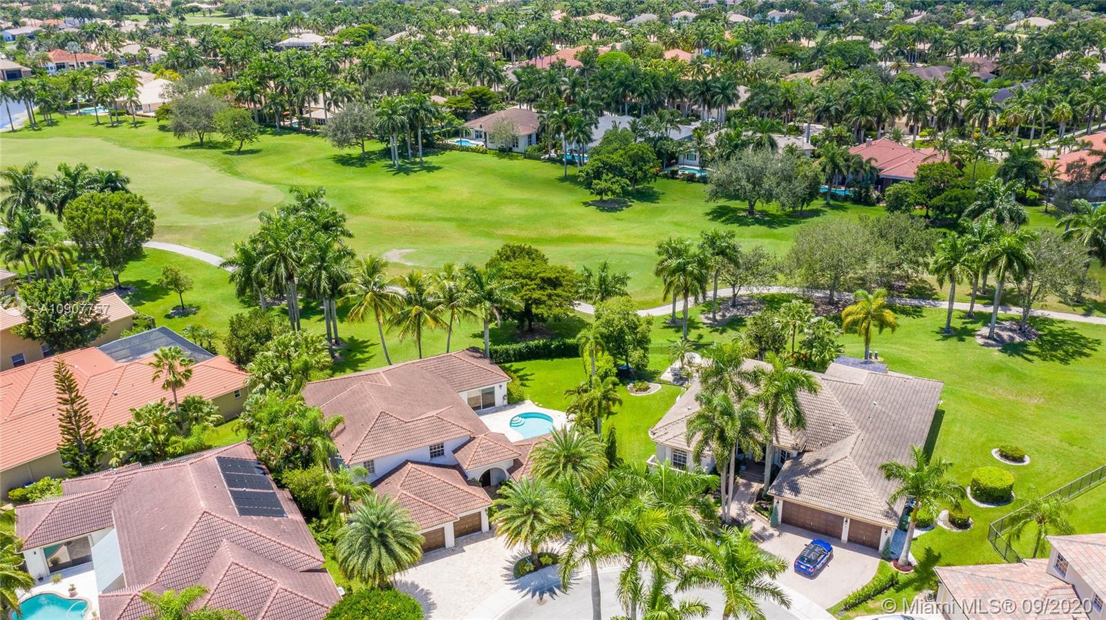 2467 Eagle Run Drive Weston, FL 33327 - Photo 30 of 33 a view of a garden with a building in the background