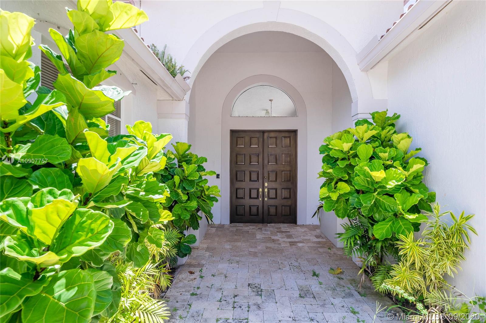 2467 Eagle Run Drive Weston, FL 33327 - Photo 4 of 33 a front view of a house with garden