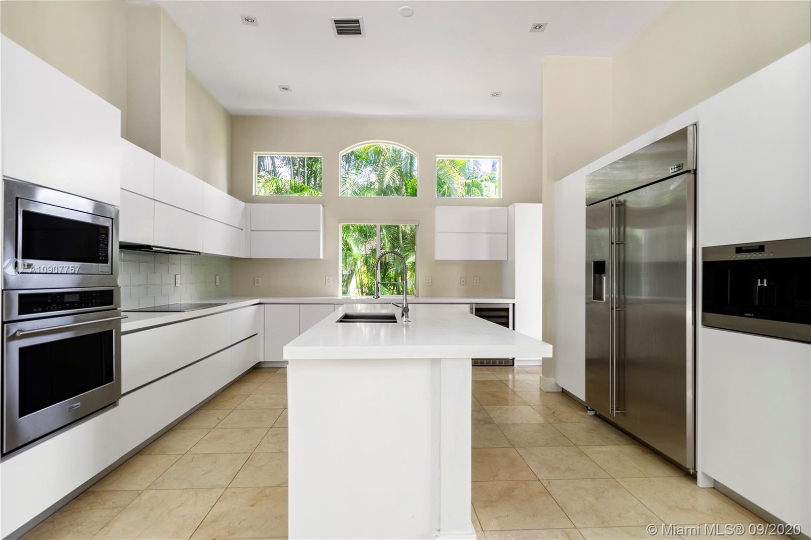 2467 Eagle Run Drive Weston, FL 33327 - Photo 5 of 33 a kitchen with stainless steel appliances kitchen island granite countertop a sink and a refrigerator