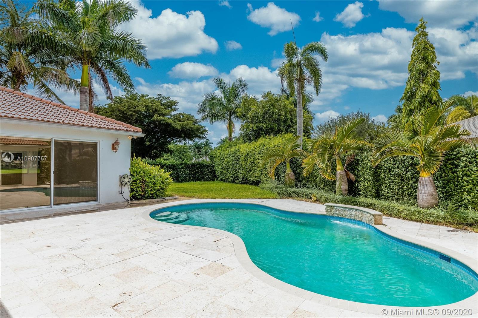 2467 Eagle Run Drive Weston, FL 33327 - Photo 9 of 33 a swimming pool with outdoor seating and garden