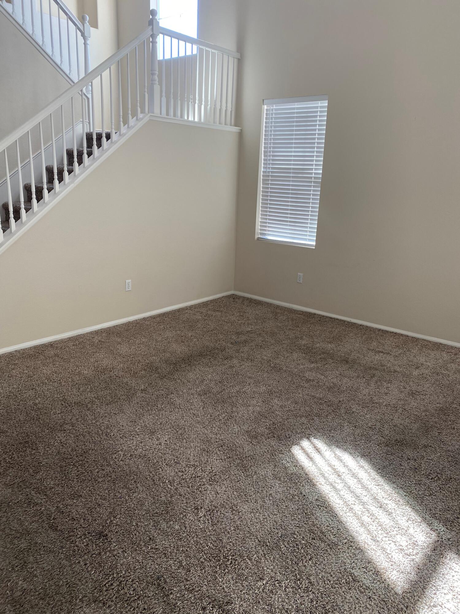 a view of an empty room with stairs