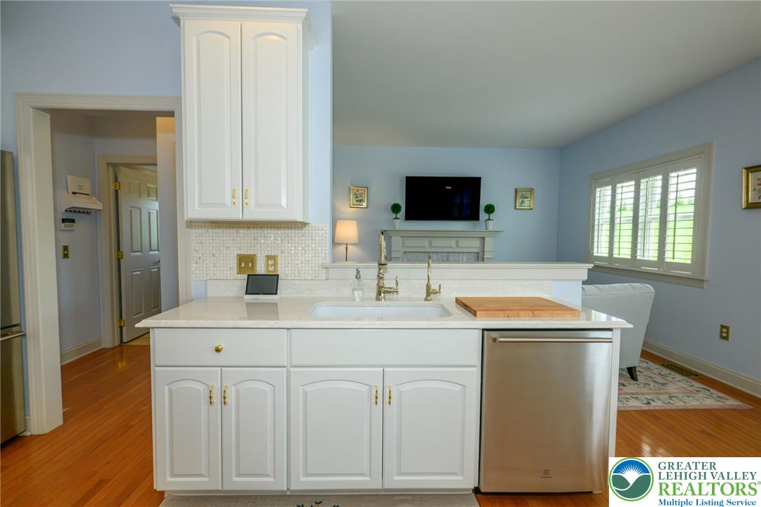 217 Gower Road Nazareth, PA 18064 - Photo 15 of 44 A well-appointed kitchen island offers a built-in sink and ample counter space, overlooking an inviting living area.