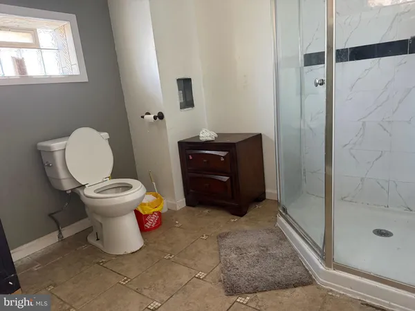 a bathroom with a toilet and a shower