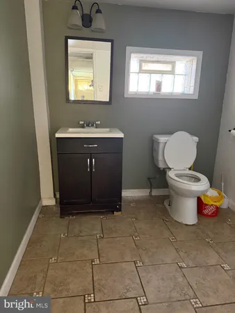 a bathroom with a sink toilet and mirror
