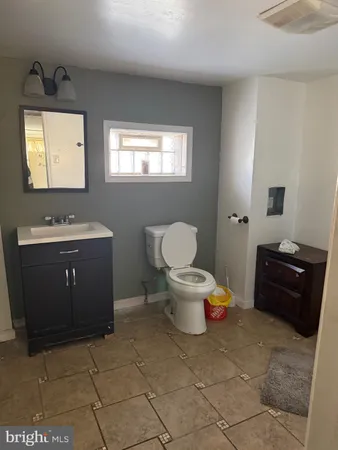 a spacious bathroom with a toilet sink and mirror