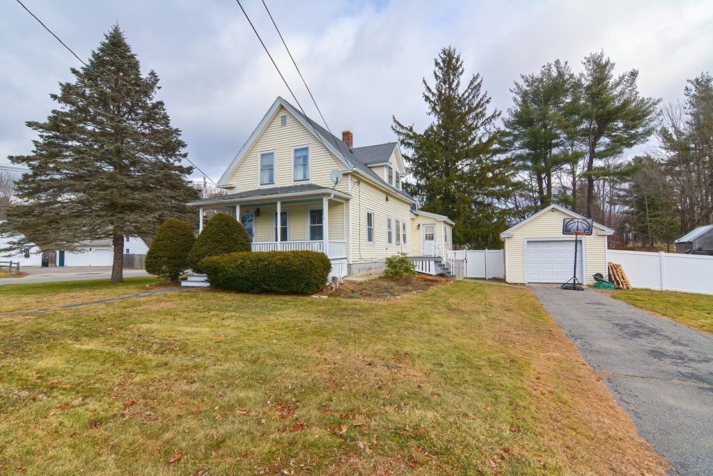 103 Maple Avenue Rutland, MA 01543 - Photo 1 of 42 a view of a house with a yard and garage