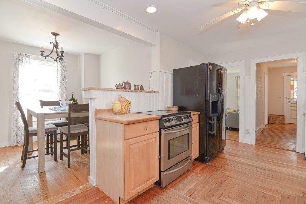 103 Maple Avenue Rutland, MA 01543 - Photo 13 of 42 a kitchen with stainless steel appliances granite countertop a stove refrigerator and a dining table with wooden floor