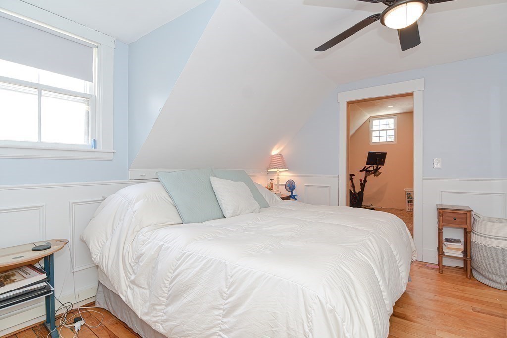 103 Maple Avenue Rutland, MA 01543 - Photo 17 of 42 a bedroom with a bed and a chandelier