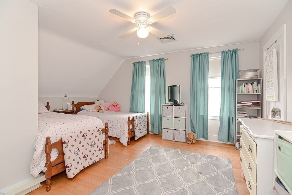 103 Maple Avenue Rutland, MA 01543 - Photo 23 of 42 a bedroom with a bed and a chandelier