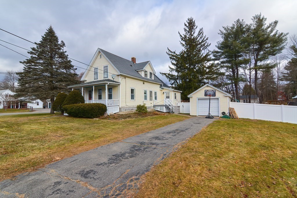 103 Maple Avenue Rutland, MA 01543 - Photo 32 of 42 a yellow house with trees in front of it