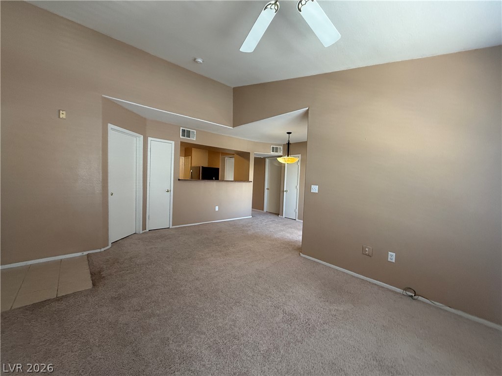 7255 West Sunset Road, Unit 2052 Las Vegas, NV 89113 - Photo 4 of 16 A spacious living area offers ample room for relaxation and entertaining, with clear sightlines to the adjacent kitchen.