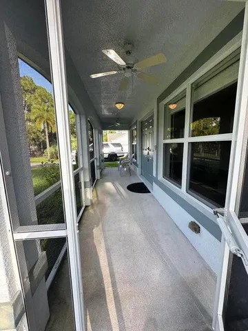 a view of living room with furniture and large window