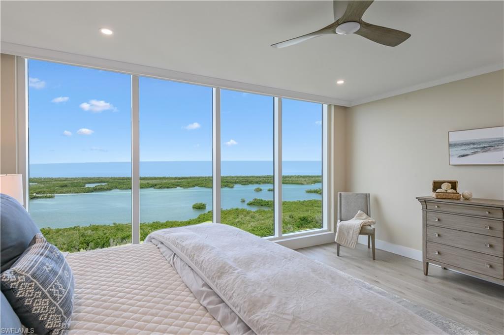 13945 Old Coast Road, Unit 1606 Naples, FL 34110 - Photo 12 of 35 a view of a bedroom with furniture and balcony