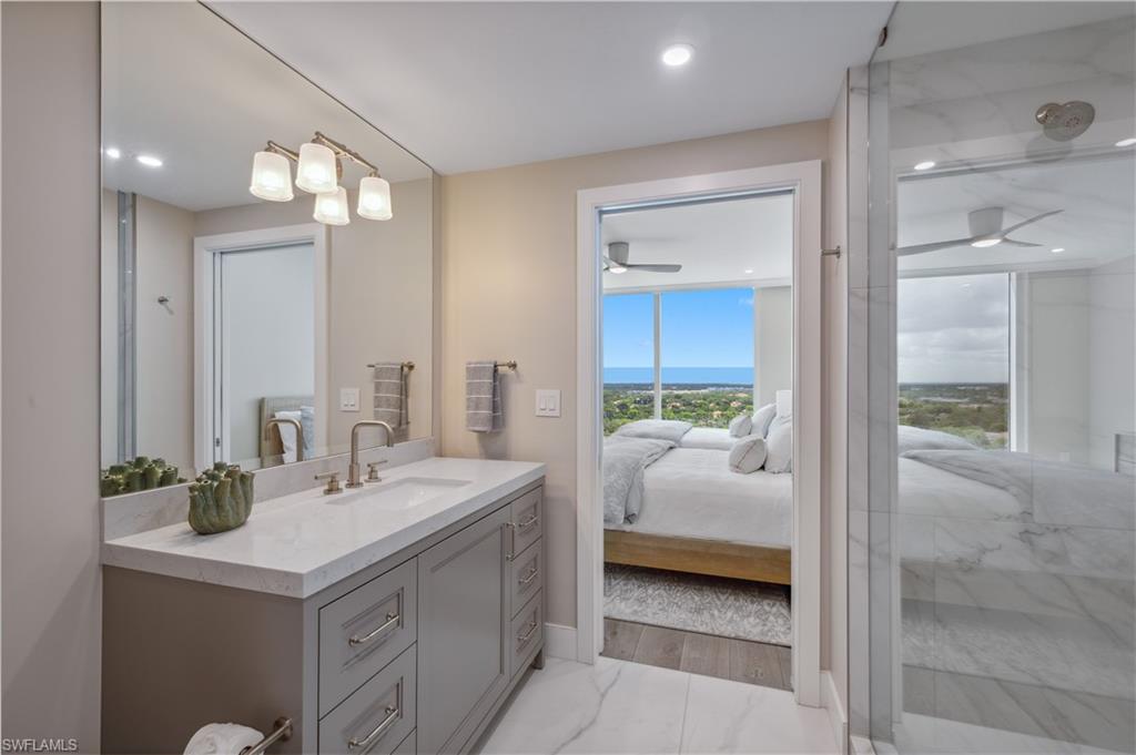 13945 Old Coast Road, Unit 1606 Naples, FL 34110 - Photo 18 of 35 a en suite bathroom with a sink and a mirror