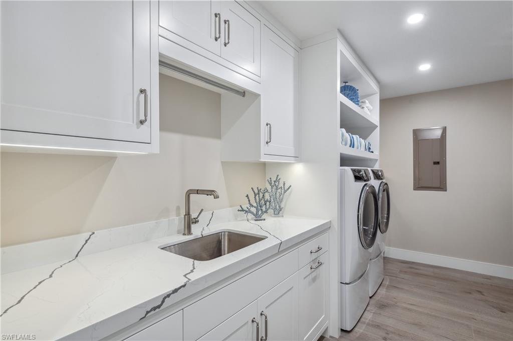 13945 Old Coast Road, Unit 1606 Naples, FL 34110 - Photo 20 of 35 a kitchen with a sink and cabinets