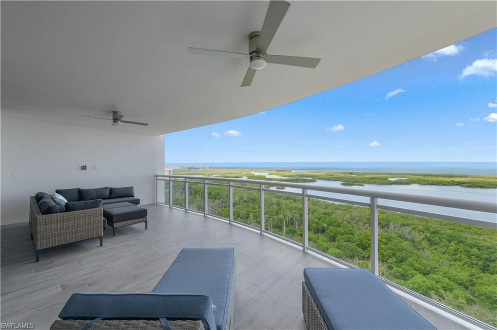 13945 Old Coast Road, Unit 1606 Naples, FL 34110 - Photo 22 of 35 a living room with furniture and a floor to ceiling window