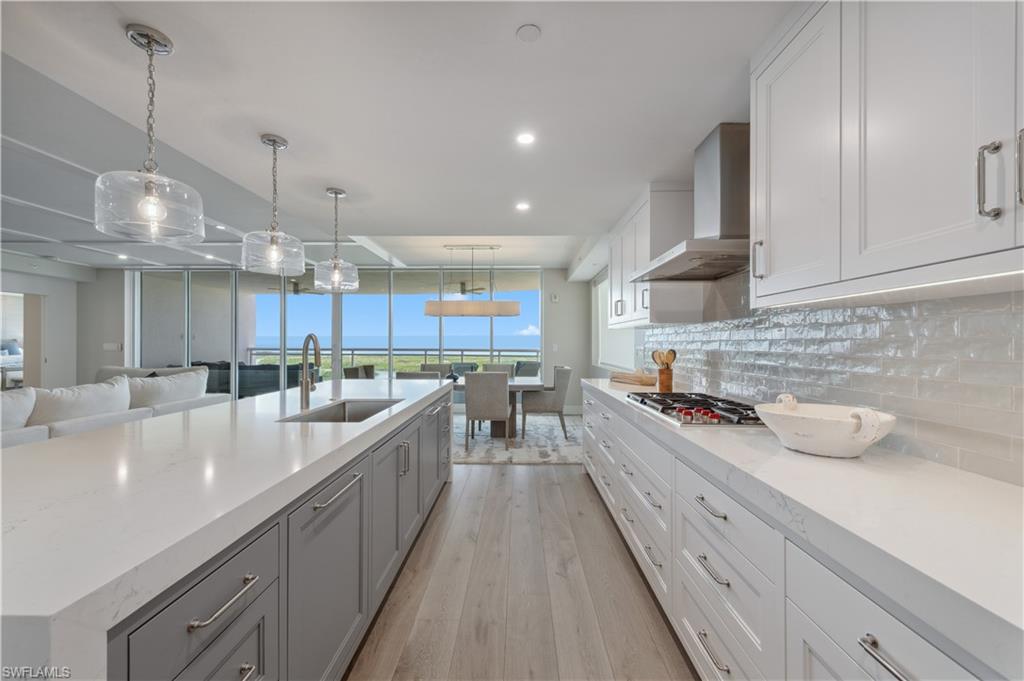 13945 Old Coast Road, Unit 1606 Naples, FL 34110 - Photo 3 of 35 a large kitchen with stainless steel appliances lots of counter space and a sink