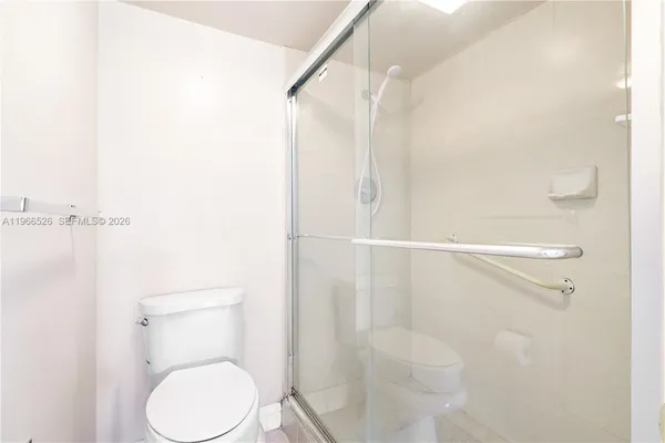 a bathroom with a toilet and a shower