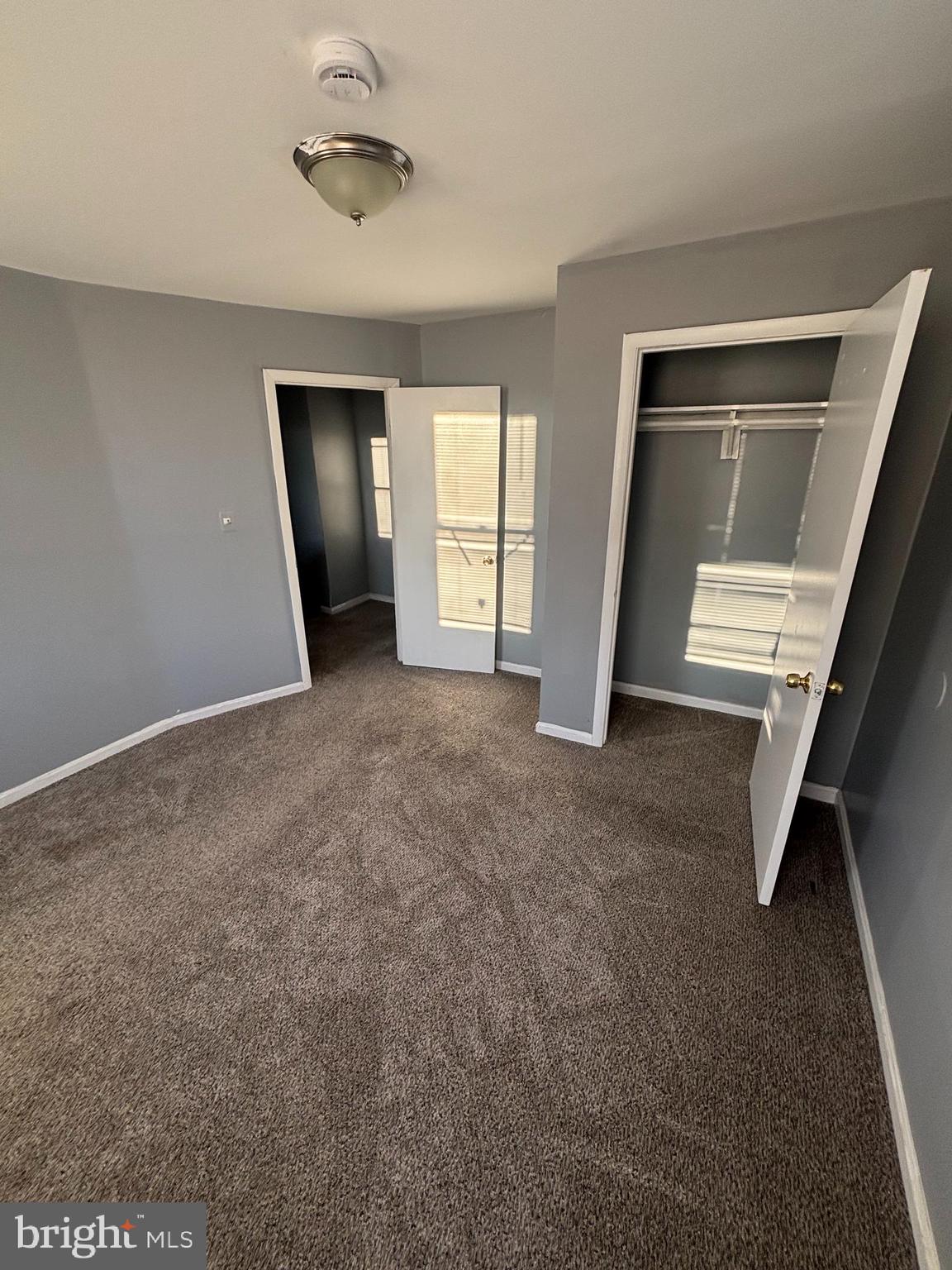 1501 North Payson Street Baltimore, MD 21217 - Photo 11 of 13 an empty room with closet and windows
