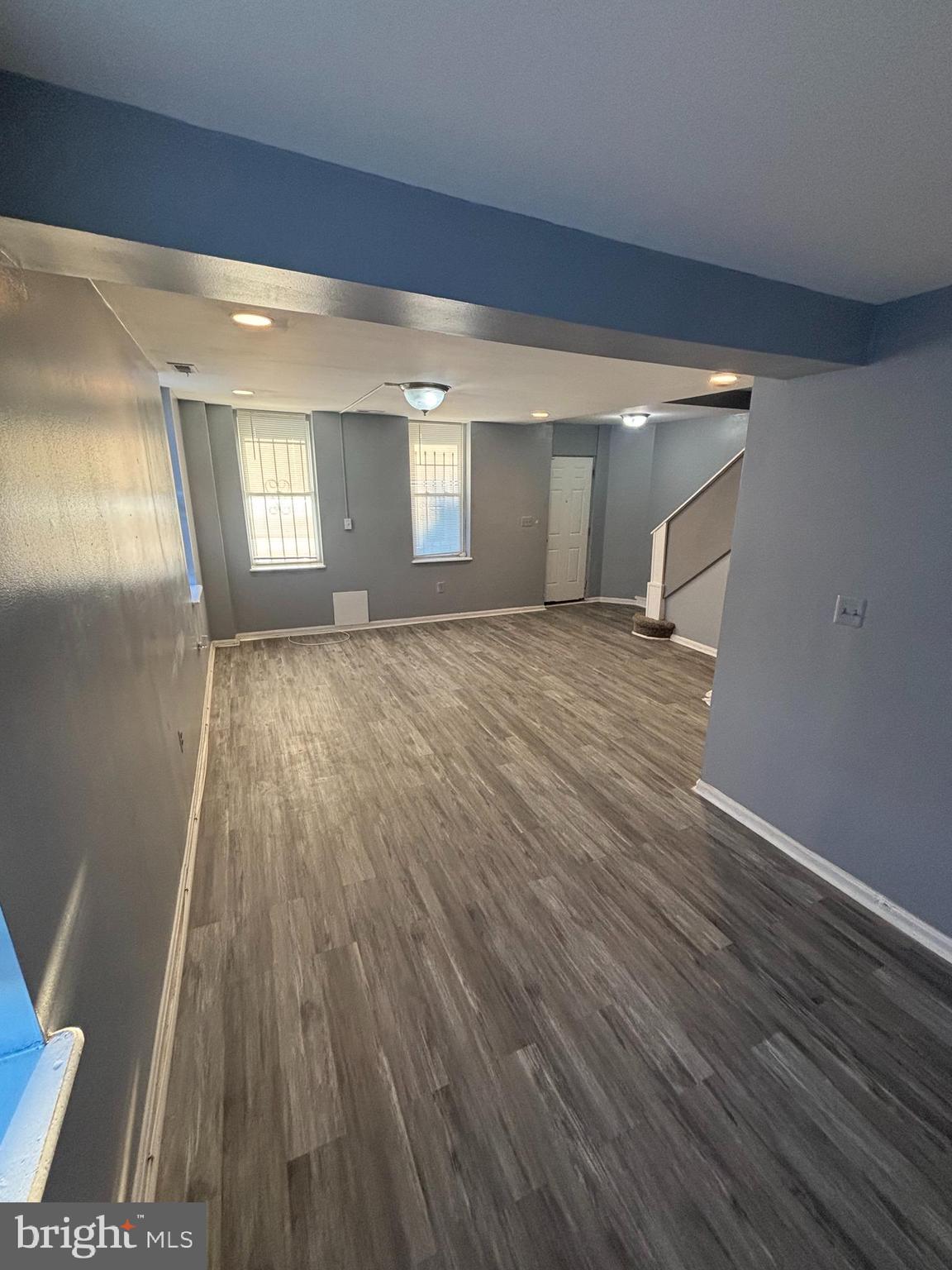 1501 North Payson Street Baltimore, MD 21217 - Photo 3 of 13 an empty room with wooden floor and windows