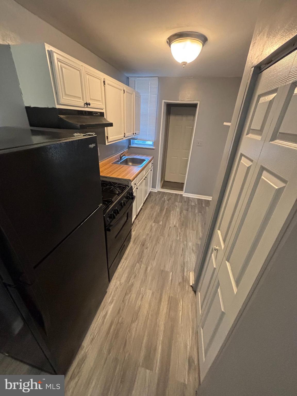 1501 North Payson Street Baltimore, MD 21217 - Photo 4 of 13 a kitchen with granite countertop a refrigerator a sink dishwasher stove and microwave