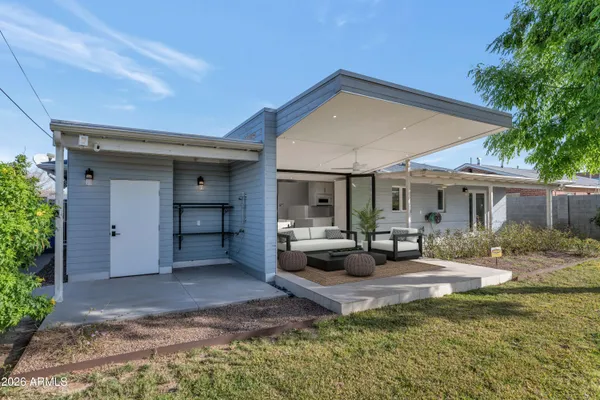 a view of a house with backyard porch and sitting area