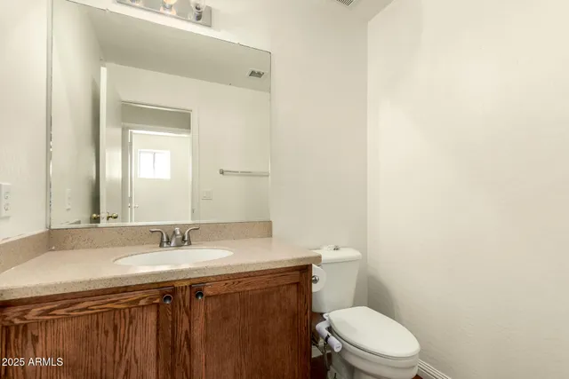 a bathroom with a sink a toilet and mirror