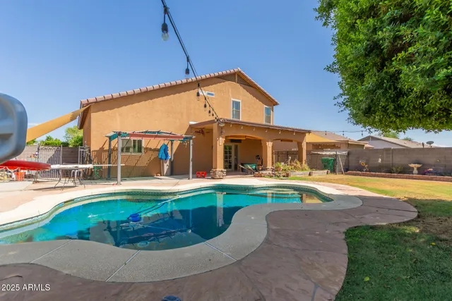 a view of a house with swimming pool and sitting area