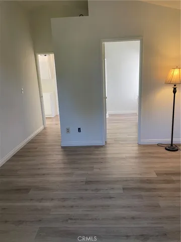 a view of a room with wooden floor