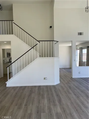 a view of entryway and hall with wooden floor