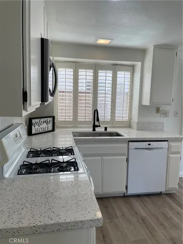 a kitchen with granite countertop a stove and a sink