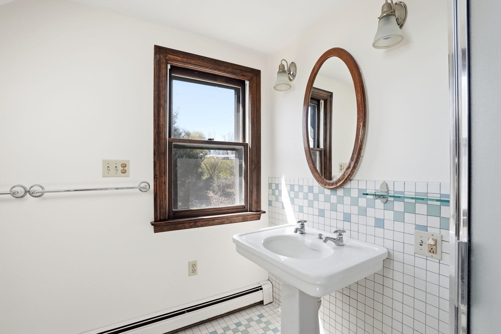 34 Governor Long Road Hingham, MA 02043 - Photo 10 of 37 a bathroom with a sink and a mirror