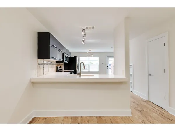 a view of kitchen with cabinets