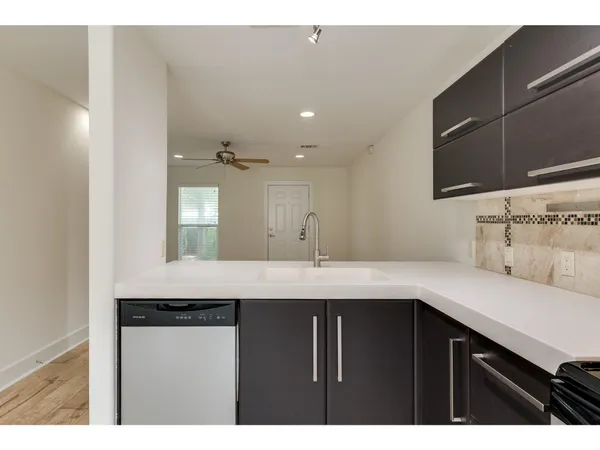 a kitchen with kitchen island a sink stainless steel appliances and cabinets