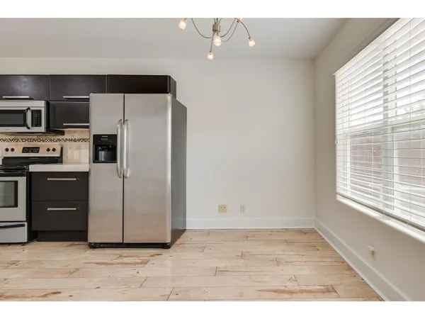 a kitchen with a refrigerator and a sink