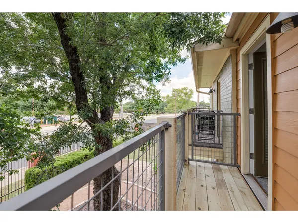 a balcony with wooden floor and outdoor space