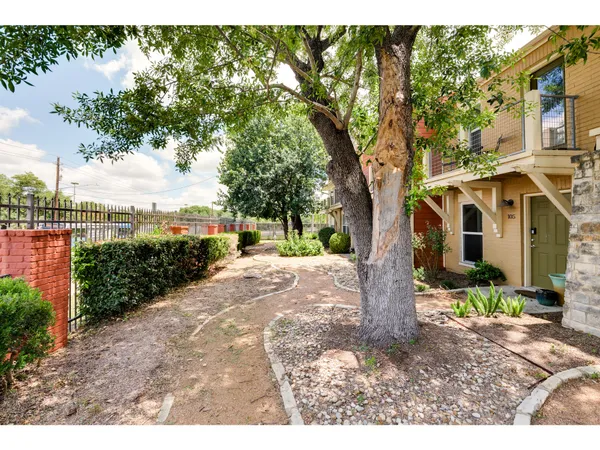 a view of a house with a tree in the background