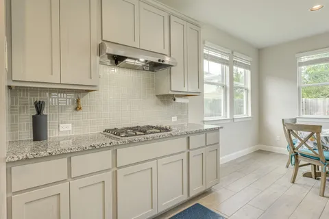 a kitchen with stainless steel appliances granite countertop a refrigerator and cabinets