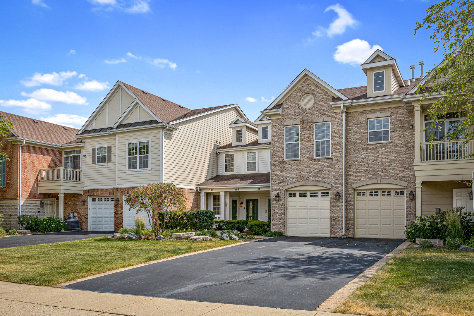 1393 Scarboro Road, Unit 202 Schaumburg, IL 60193 - Photo 1 of 1 a front view of a house with a yard