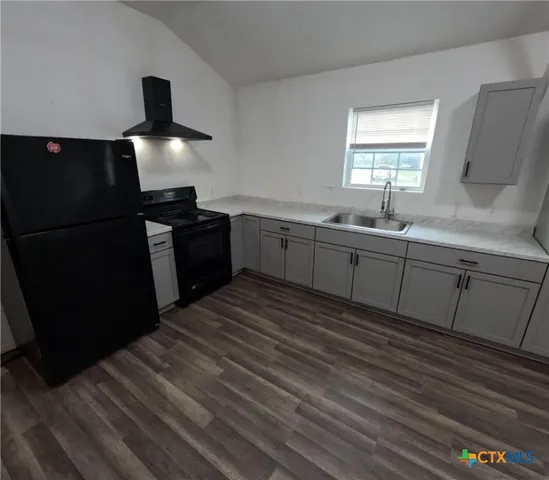 a kitchen with a sink and refrigerator