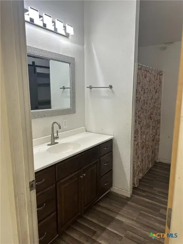 a bathroom with a sink a vanity and a mirror