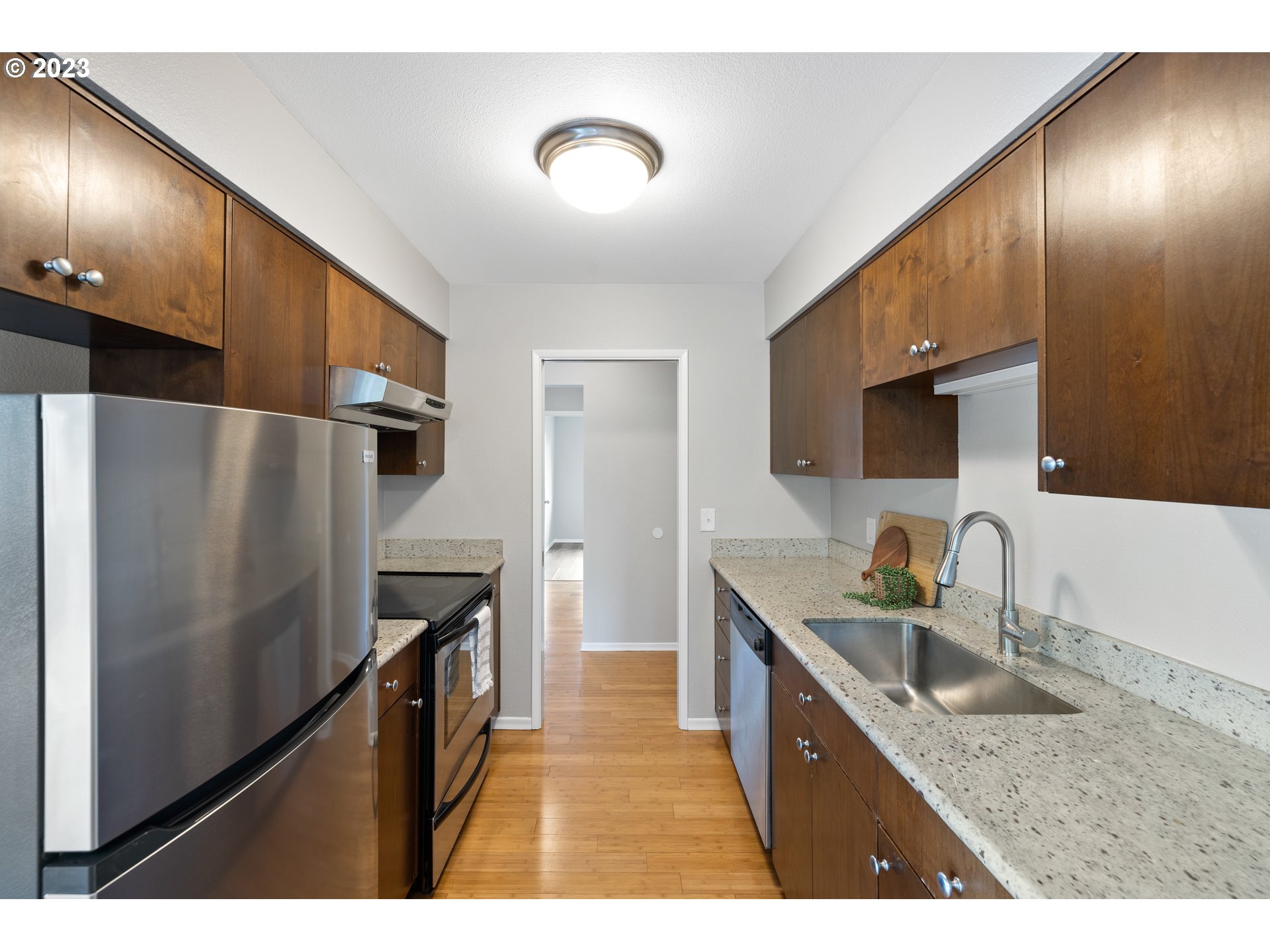 2038 Northeast Clackamas Street Portland, OR 97232 - Photo 17 of 32 a kitchen with stainless steel appliances granite countertop a sink stove and refrigerator